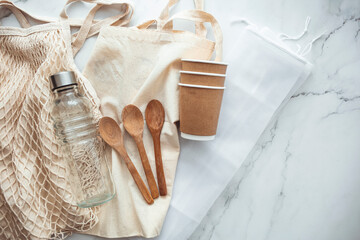 Set of Eco friendly bamboo cutlery, eco bag reusable coffee mug and water bottle. Sustainable lifestyle. Plastic free concept. Zero waste, eco friendly shopping.