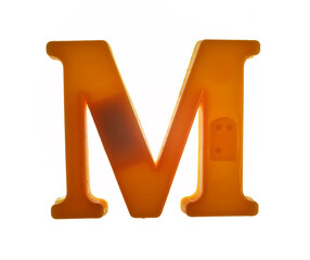 Plastic letter M on magnet isolated on white background, top view