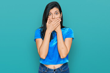 Young hispanic woman wearing casual clothes shocked covering mouth with hands for mistake. secret concept.