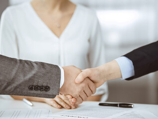 Business people shaking hands finishing contract signing, close-up. Business communication concept. Handshake and marketing