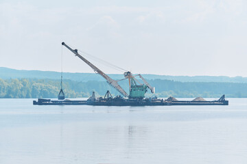 dredging boat is working to deepen the fairway on the river