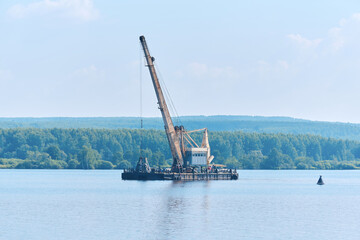 dredger is working to deepen the fairway on the river