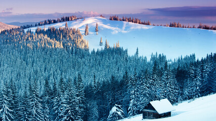 Winter morning in the mountains. View of the old farm.