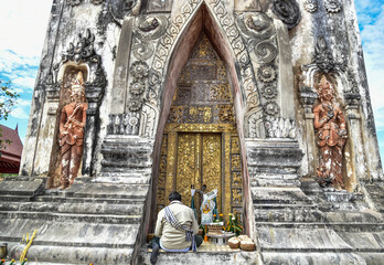 Lao people are making an offering to Pha That Ing Hang in Savannakhet, Laos.