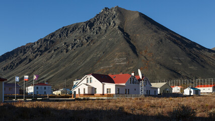 Northern town in the Arctic. Egvekinot, Chukotka, Far North of Russia. On the slope of the mountain, schoolchildren laid out a text made of stones "Graduation 2010. We are 2013".