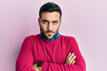 Obraz premium Young hispanic man wearing casual clothes skeptic and nervous, disapproving expression on face with crossed arms. negative person.