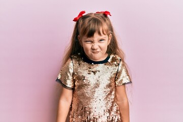 Little caucasian girl kid wearing festive sequins dress skeptic and nervous, frowning upset because of problem. negative person.