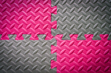Colorful Jigsaw Foam flooring tiles or mat in grey and pink in metal floor look for anti slip and safety , vignette effect for background texture