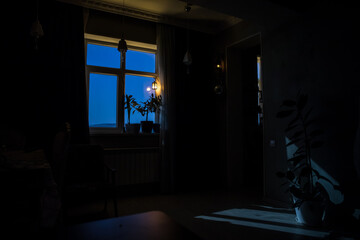 Night scene of moon seen through the window from dark room. Moonlight inside dark room. Long exposure shot