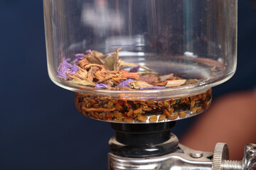 Making herbal tea with a vacuum siphon.