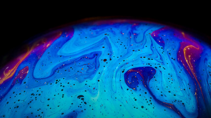 Fluid soap bubble looking like planets. Psychedelic colorful abstract art with urreal patterns of...