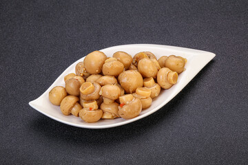 Pickled champignons in the bowl