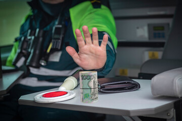 Street lighting. A special car inspector shows a hand gesture. On the table is a wallet and a red...