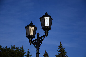Fototapeta na wymiar old street lamp of blue sky