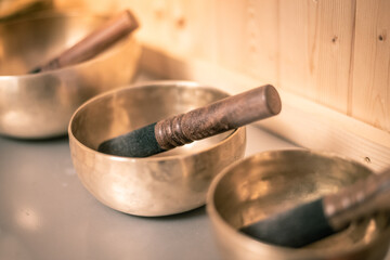 Close up view of Tibetan bells with wooden background. Accessories for the practice of holistic...