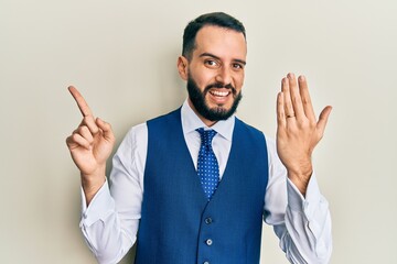 Young man with beard wearing engagement ring smiling happy pointing with hand and finger to the side