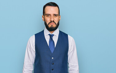 Young man with beard wearing business vest depressed and worry for distress, crying angry and afraid. sad expression.