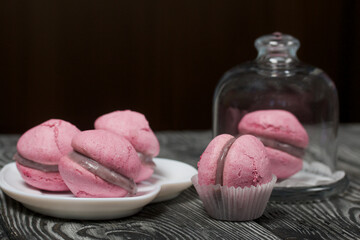 Lavender macaroni cake with white chocolate and blueberries. Lies on pine boards.