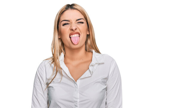 Young caucasian woman wearing casual clothes sticking tongue out happy with funny expression. emotion concept.