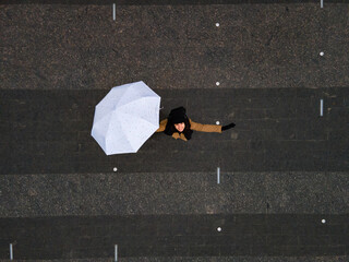 young happy woman with umbrella looking up