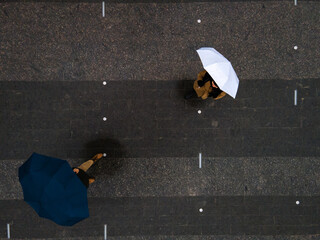 man and woman with umbrella view from above