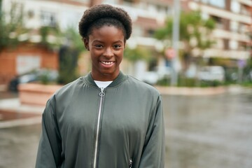 Fototapeta premium Young african american girl smiling happy standing at the city.
