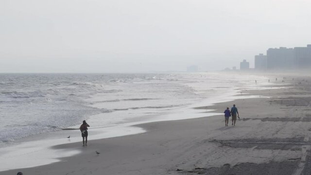 Tourists walking on beach in Atlantic City
