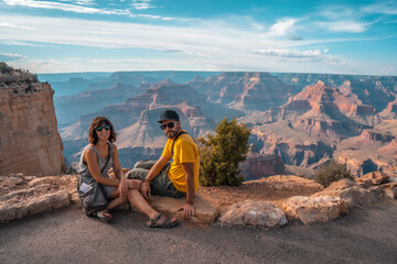 A young couple in the sunset views at Mojave Point in Grand Canyon. Arizona.