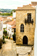 Narrow and colorful streets, facades and balconies of Obidos