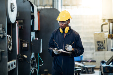 Quality control inspector checking workers at factory. Engineering Worker team working in Heavy Industry Manufacturing Facility. Engineer Operating lathe Machinery. American African people.