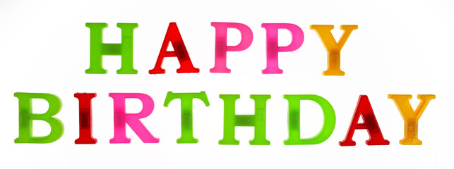 Happy birthday word lined with plastic multicolored letters on white background, isolate
