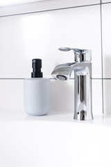 Contemporary chrome washbasin mixer. Modern mixer in bathroom
