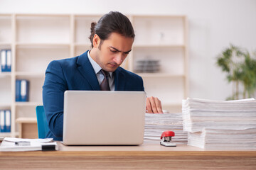 Young male employee unhappy with excessive work