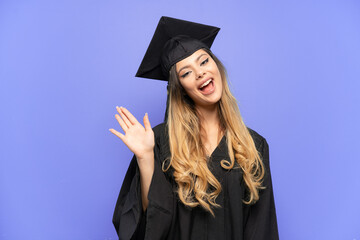Young university graduate Russian girl isolated on white background saluting with hand with happy expression