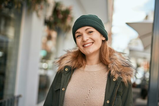 Young caucasian girl smiling happy standing at the city.