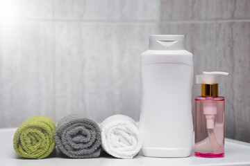 A set for taking a shower, bath in the hotel. Towels, shampoo and balm for body and hair.