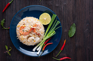 Fried rice with shrimp  and squid on the blue  dish on wooden table