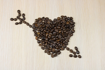 The coffee beans are laid out in the shape of a heart with an arrow.