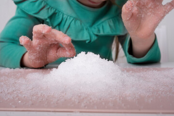 Laboratory, kids chemical experiments day 2 of 14. a mountain of artificial snow on the table, a...