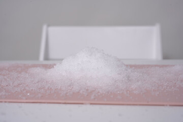 Laboratory, chemical experiments day 2 of 14. a mountain of artificial snow on a table made of...