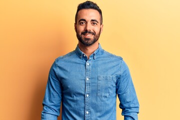 Obraz premium Young hispanic man wearing casual clothes with a happy and cool smile on face. lucky person.