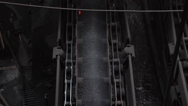 Sintering plant. Agglomerate moves along the conveyor belt.