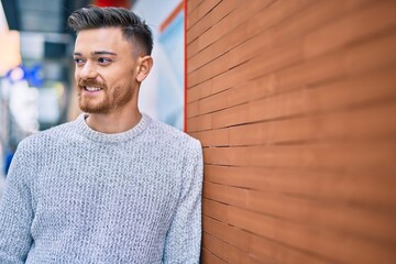 Young caucasian man smiling happy standing at the city.