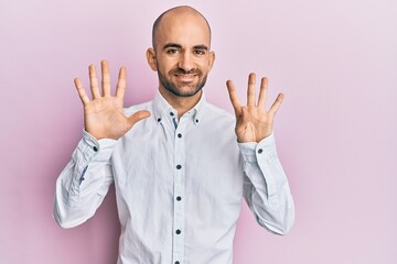 Young hispanic man wearing casual clothes showing and pointing up with fingers number nine while smiling confident and happy.