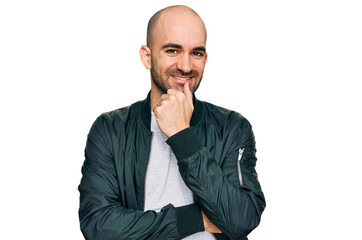 Young hispanic man wearing casual clothes looking confident at the camera with smile with crossed arms and hand raised on chin. thinking positive.