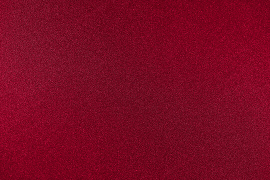 Rich red background color. One-color texture with a small noisy glitter. Copy space