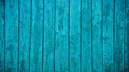 Aged blue planks with peeled paint. Blue background. Close-up. Copy space. Defocus.