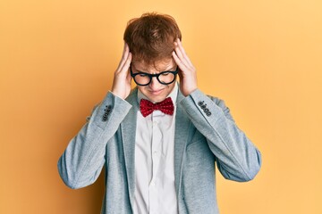 Young caucasian nerd man wearing glasses wearing hipster elegant look with bowtie suffering from...