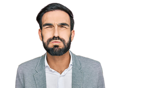 Young hispanic man wearing business clothes puffing cheeks with funny face. mouth inflated with air, crazy expression.
