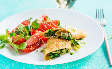 Omelette rolls on a plate. Homemade fried omelet rolls with chopped greens. Healthy low carb recipe.